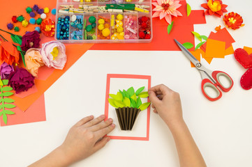 Child makes a postcard flat lay. Gift for mother a holiday on 8 March.