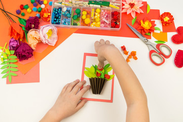 Child makes a postcard flat lay. Gift for mother a holiday on 8 March.