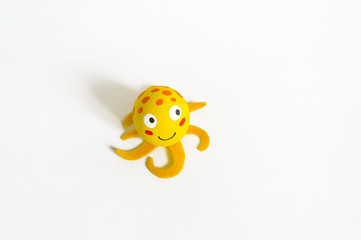 Easter holiday concept with cute handmade eggs: sea animal yellow octopus.