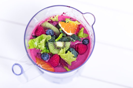 Fruits and berries in blender, macro