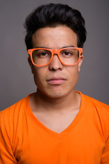 Obraz premium Portrait of young Asian man against gray background