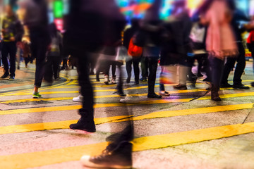 Blurred image of people moving in crowded night city street.. Hong Kong