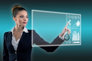 Young business lady works with virtual graphic interface in futuristic office