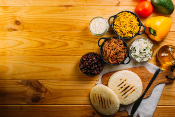 Top view of South American food called arepa and different ingredients
