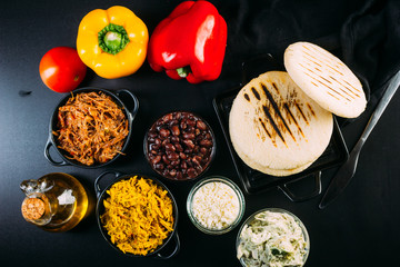 Top view of South American food called arepa and different ingredients