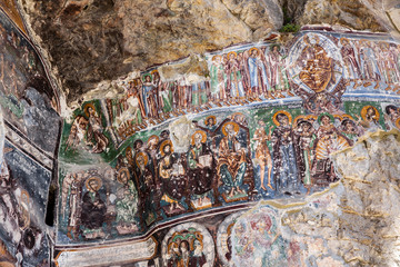  Sumela monastery courtyard under the rock. Remains of old fresco are seen on several walls.Macka,...