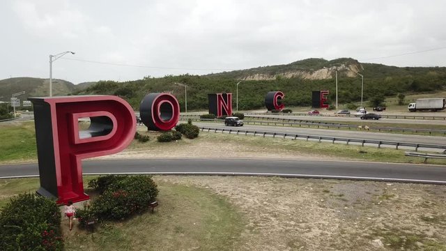 AERIAL: Revealing las letras from behind a bush.