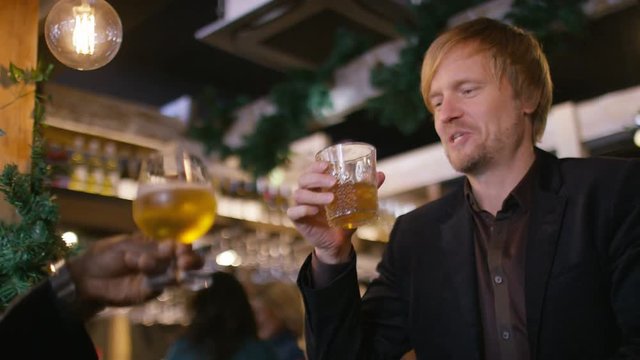 Handsome man sits down and drinks with his friend