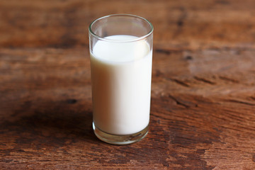 glass of fresh  milk on wooden table background 