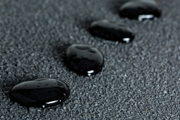 Stones with drops of water on a black background
