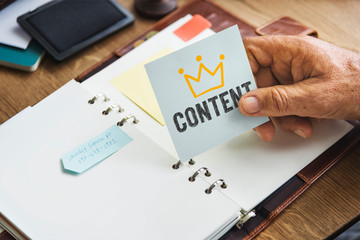 Senior hand holding a Content sticky note