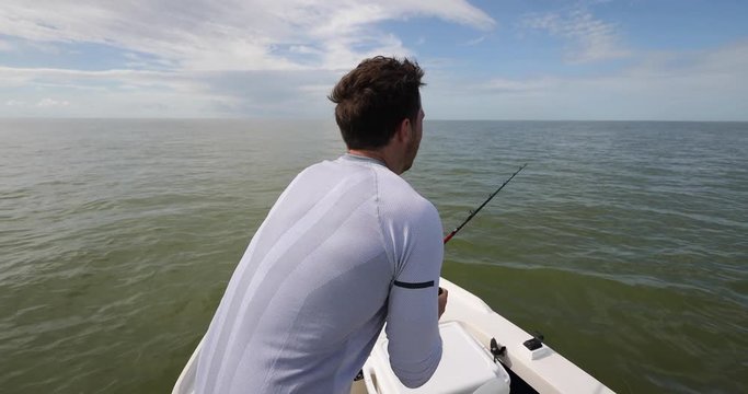 Man fighting and winning battle fight against shark while shark fishing on boat in Florida, USA. Sport fishing Travel tourist man catch and release of spinner shark. From Florida keys.