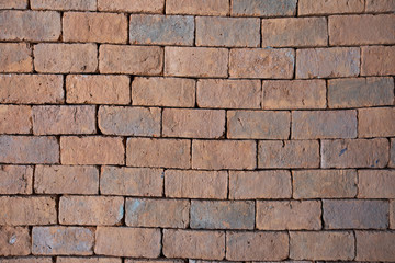 Red bricks arranged in rows near, Wall texture closeup