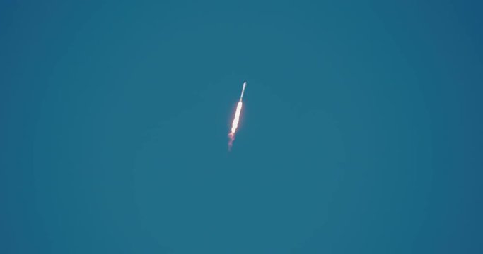 Space rocket flying into space in 4K at  120 fps slow motion.  Lots of nice flames and smoke against a clear blue sky.