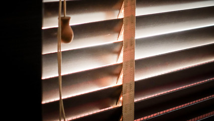 evening sun light outside with wooden window blinds, sunshine and shadow on window blind,...