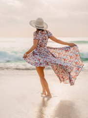 Attractive woman in summer dress on Bali beach
