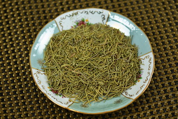 dried rosemary  in a porcelain plate - close up of a rosemary background food