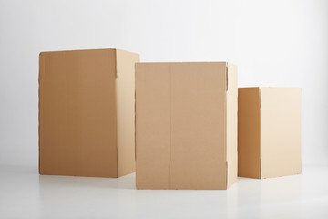 Three blank cardboard boxes, in white background