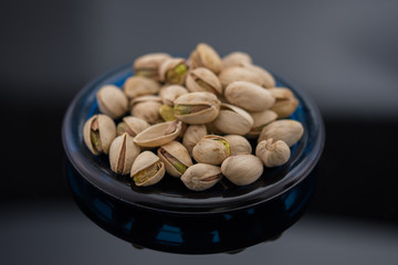 Roasted pistachio seeds with shell in bowl