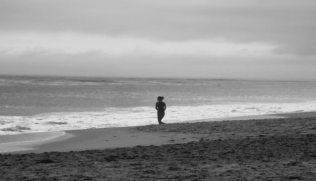 Girl running at the beach - B&W version 