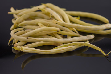 Pile of fresh green beans over a white  background