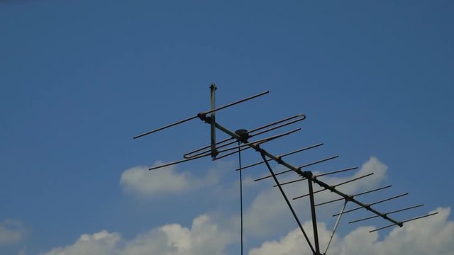 Old Style TV Aerial and Clouds in Blue Sky Time lapse