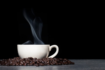 Cup of coffee with coffee bean on black background