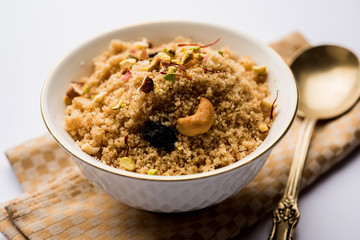 Semolina Halwa / Sooji ka Halva or sweet Rava Sheera or shira - Indian festival sweet made of semolina, nuts and Ghee