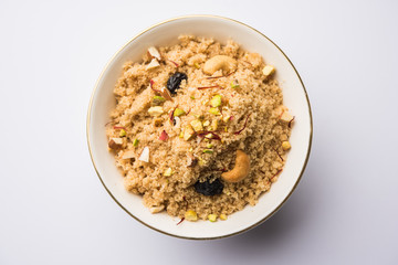 Semolina Halwa / Sooji ka Halva or sweet Rava Sheera or shira - Indian festival sweet made of semolina, nuts and Ghee