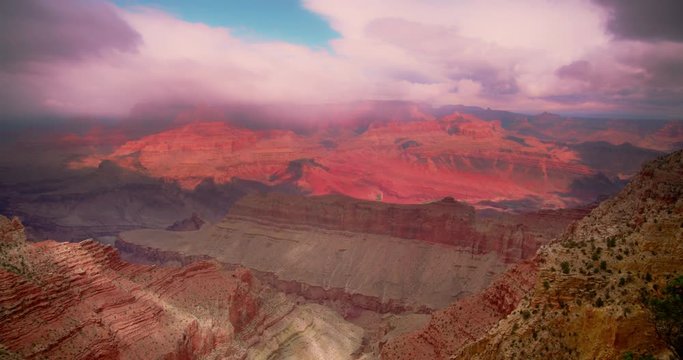 Grand Canyon National Park vista during daytime with blue skies and wispy clouds.  4K DCI. Camera pans left.