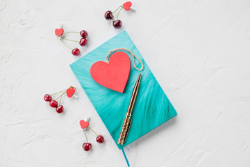 azure notebook, clips, pen and red hearts on white background. Flat lay top view Place for text .Mock up Copy space. Goal, mean, resolution, congratulation.Valentine's day background.Mothers day