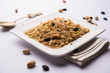 Semolina Halwa / Sooji ka Halva or sweet Rava Sheera or shira - Indian festival sweet made of semolina, nuts and Ghee