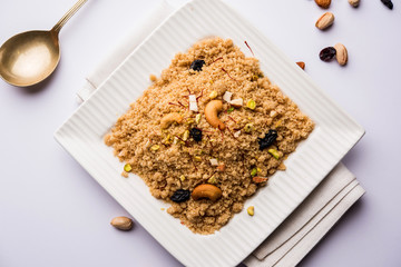 Semolina Halwa / Sooji ka Halva or sweet Rava Sheera or shira - Indian festival sweet made of semolina, nuts and Ghee