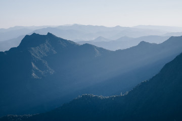 Mountain layer with sun ray scenic landscape morning in bright sky.