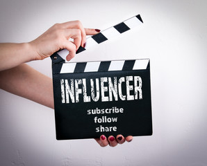 Vlogger and influencer social media marketing concept. Female hands holding movie clapper