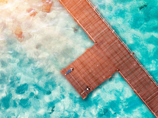 aerial top view of couple lover laying on floor of the wooden pier bridge, roman in vacation holidays and valentine day CONCEPT