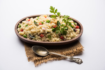 Rava Upma / Uppuma - south indian breakfast served in a bowl. selective focus