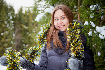 Portrait of a girl in a pine forest on a winter day