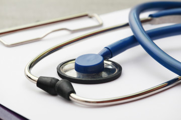 A stethoscope and a clipboard for notes as a medical check concept	
