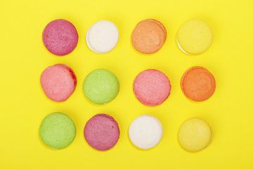 Bright background with rows of macaroons and copy space
