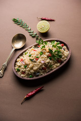Rava Upma / Uppuma - south indian breakfast served in a bowl. selective focus
