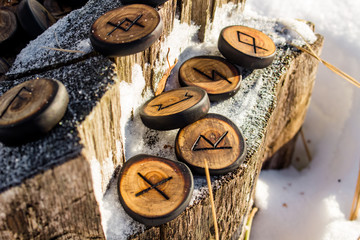Runes carved from wood on the snow - Elder Futhark
