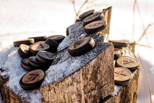 Runes carved from wood on the snow - Elder Futhark
