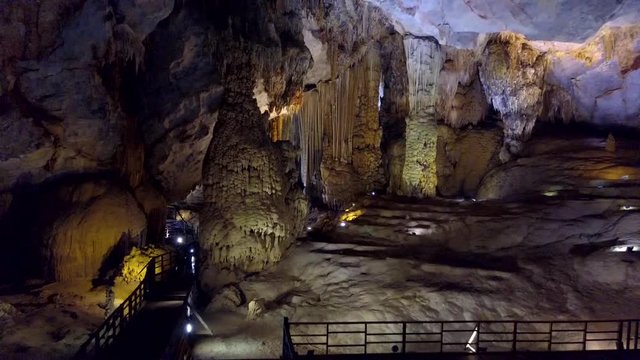 PHONG NHA/VIETNAM - MAY 10 2018: mysterious beauty of Paradise Cave with brightly lit ceiling and dark bottom places and giant stalactite columns on May 10 in Phong NhaKe Bang