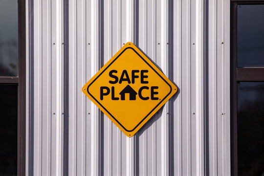 Safe place sign of a light metal wall of a building.