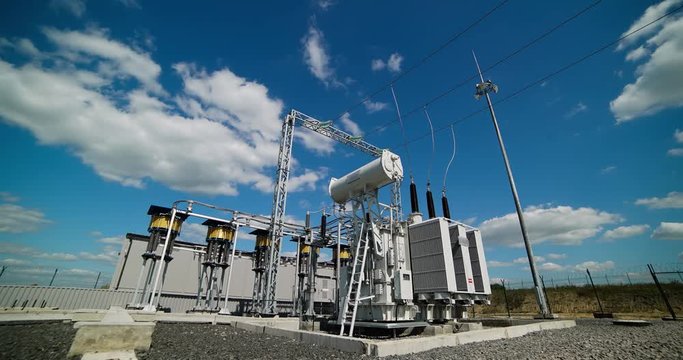 Timelaps: powerful electrical transformer. Industrial high-voltage substation power transformer at the power plant.