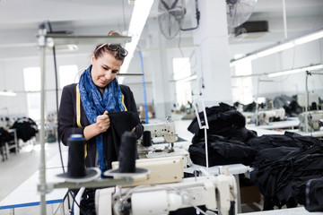 Woman designer working in textile factory