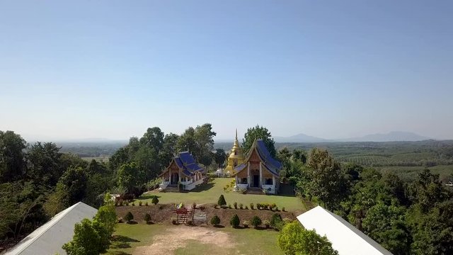 Panning up to reveal Pusang Blue roof Pai Hao Temple Northern Thailand