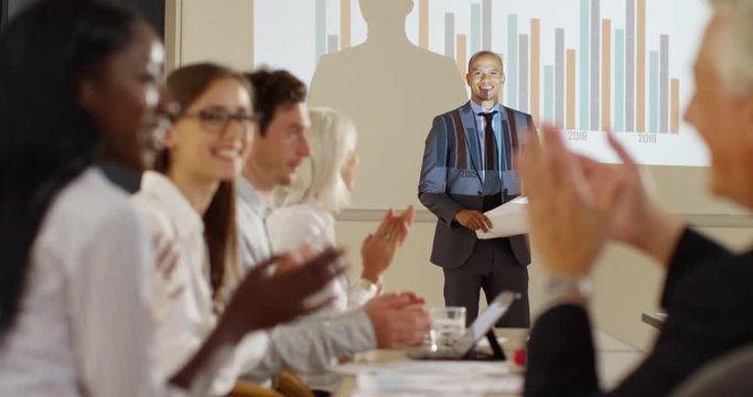 4K Enthusiastic extrovert businessman delivering fun presentation in a meeting
