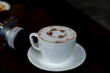 cup of coffee on wooden table